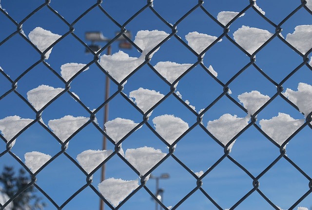 Chain link fence with snow.