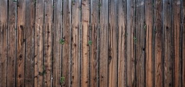 A wooden fence in need of repair.