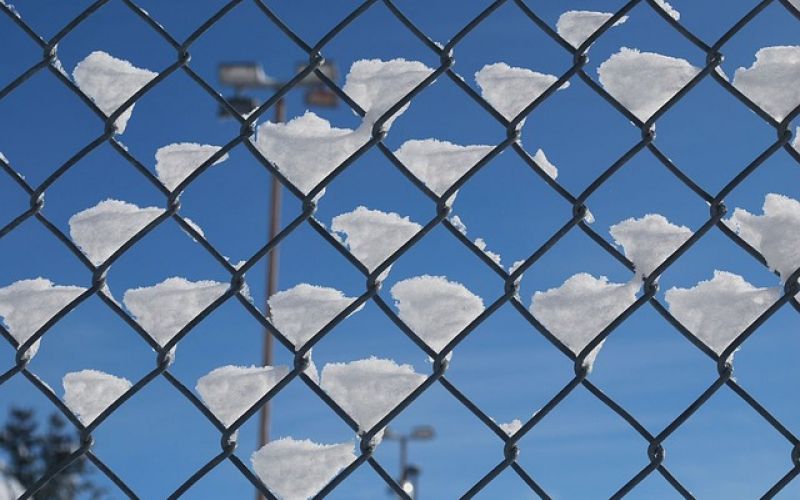 Chain link fence with snow.