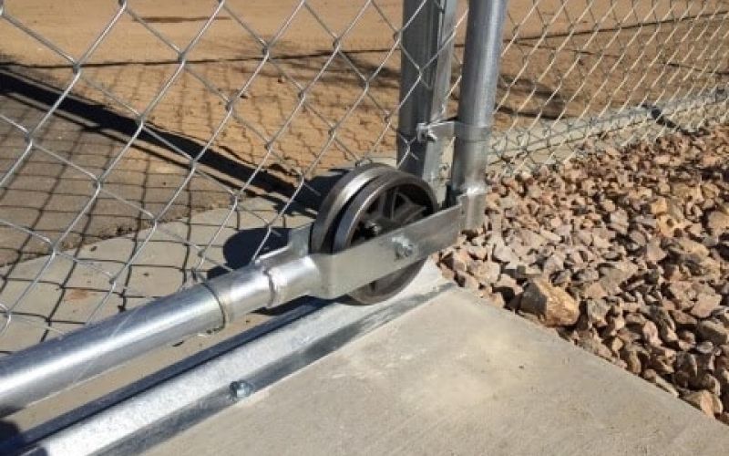 Closeup view of rolling chain link gate wheel.