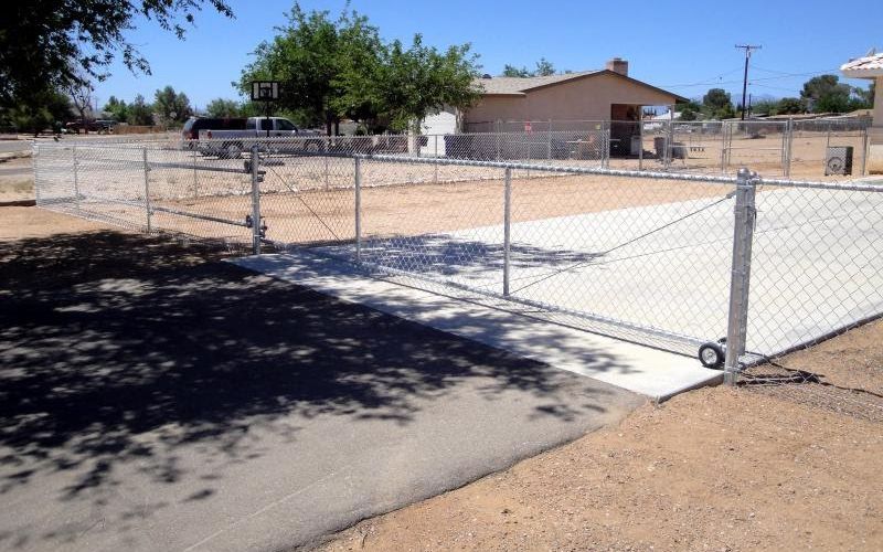 Chain link rolling gate on concrete.