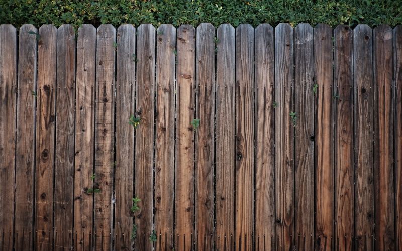 A wooden fence in need of repair.